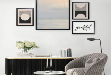 A gallery wall in a living room. Creams and black.