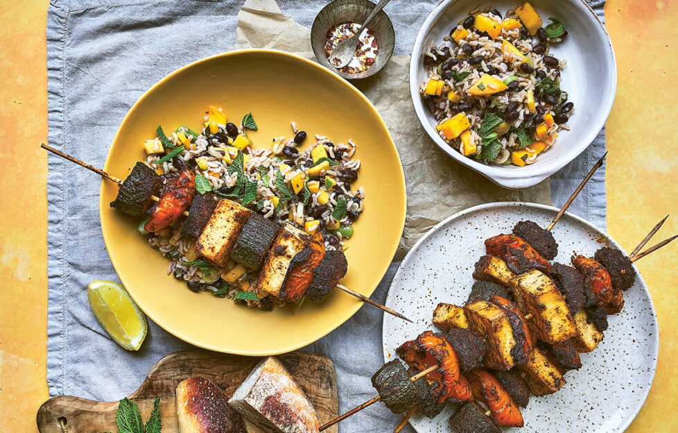 jerk chicken skewers on plate with mango rice