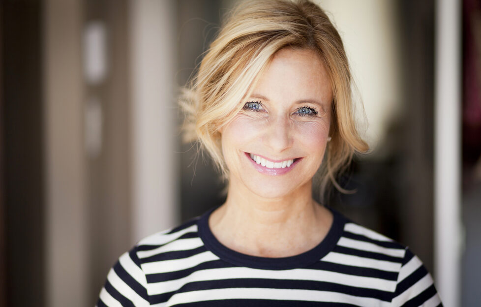 Closeup Of A Mature woman smiling At The Camera;