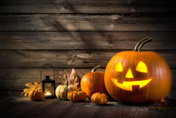 Halloween pumpkin head jack lantern on wooden background;