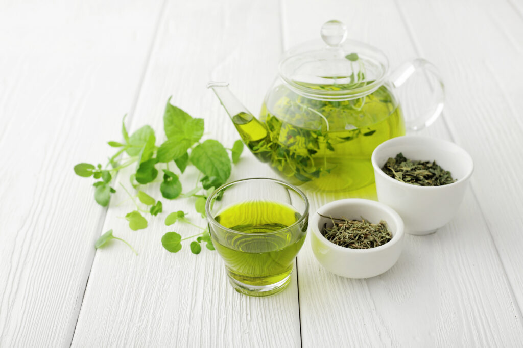 healthy green tea cup with tea leaves ; 