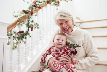 Grandmother on stairs with baby at Christmas