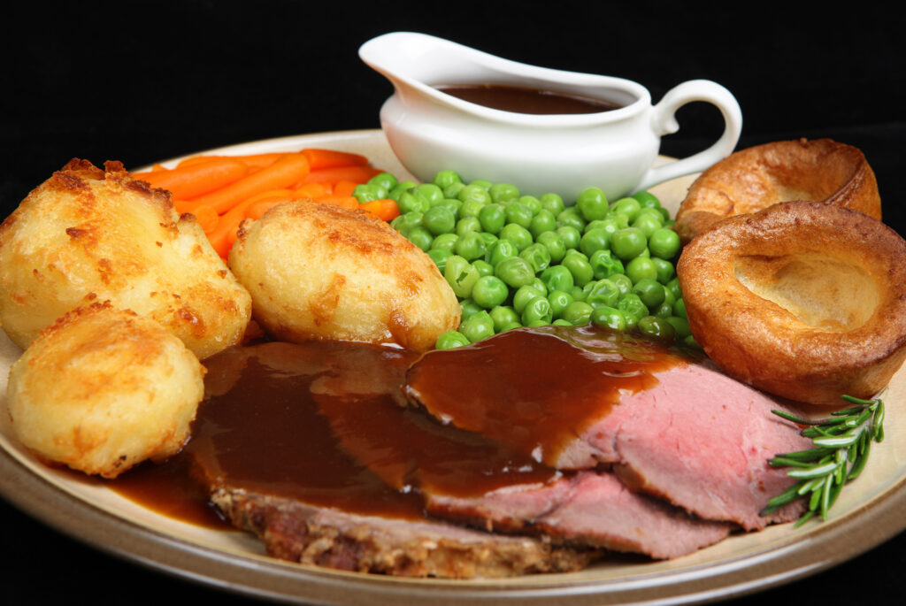 British roast beef dinner with Yorkshire puddings.; 