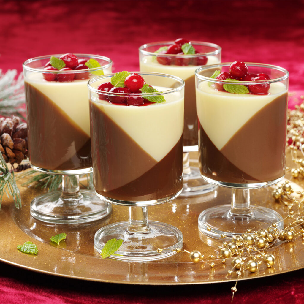4 glasses of chocolate dessert, diagonal divides between milk, dark and white, stewed fruit on top