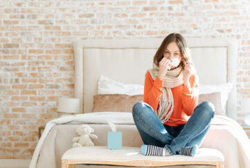 Upset young woman suffering from influenza at home;
