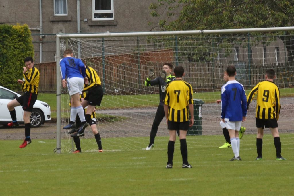 Jordan Norman outjumps the Dumbarton defence to score with a header during the Under 15 League Cup semi final win over Dumbarton United Blacks.