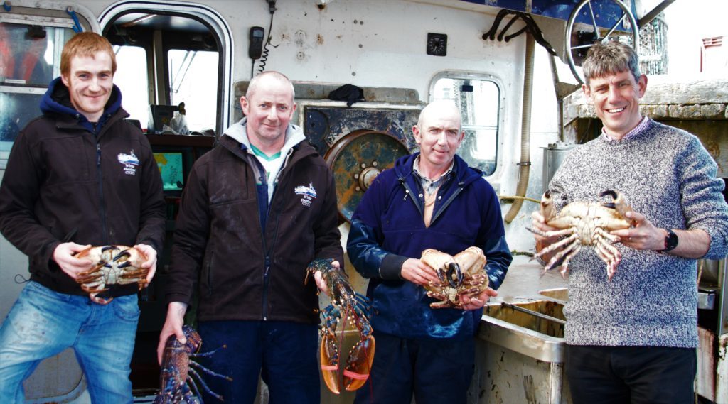 Alistair Dutton on board with the crew of the White Heather fishing boat.