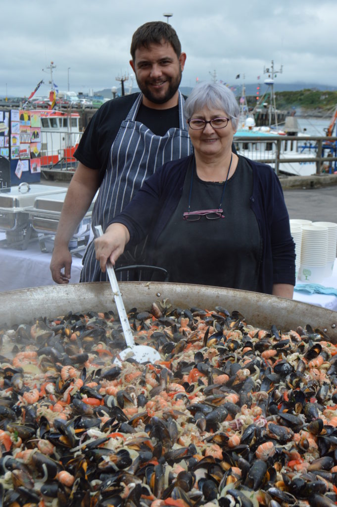 ​Harry Marshall and Jean MacNaughton of the West Highland Hotel once again cooked up and served two huge pans of seafood. Photograph: Joanne Simms