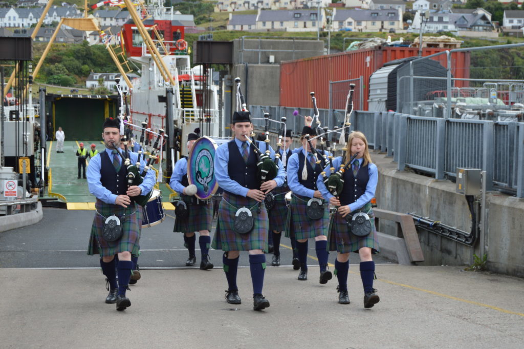 ​Isle of Skye Pipe Band marched off the ferry from Armadale and into Mallaig. Photograph: Joanne Simms