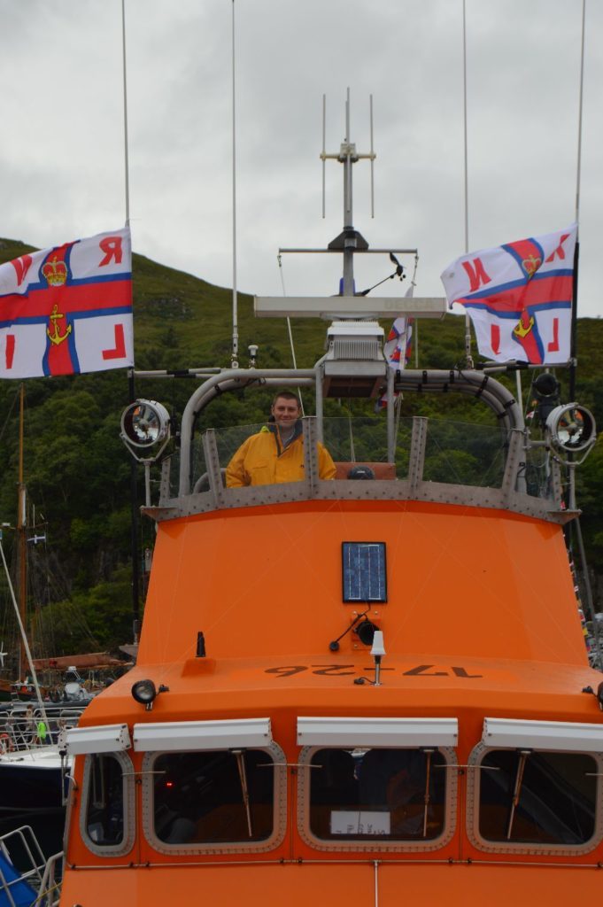 ​Crew member Hugo Martin on the flying bridge of the Severn class lifeboat at Mallaig.