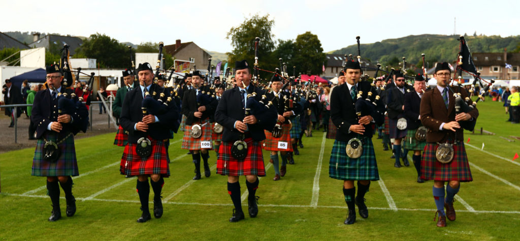 Prizewinning pipers march to the members’ tent.