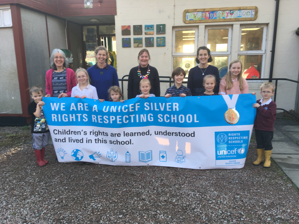 Ulva Primary School shows off its Silver Rights Respecting School Award banner.