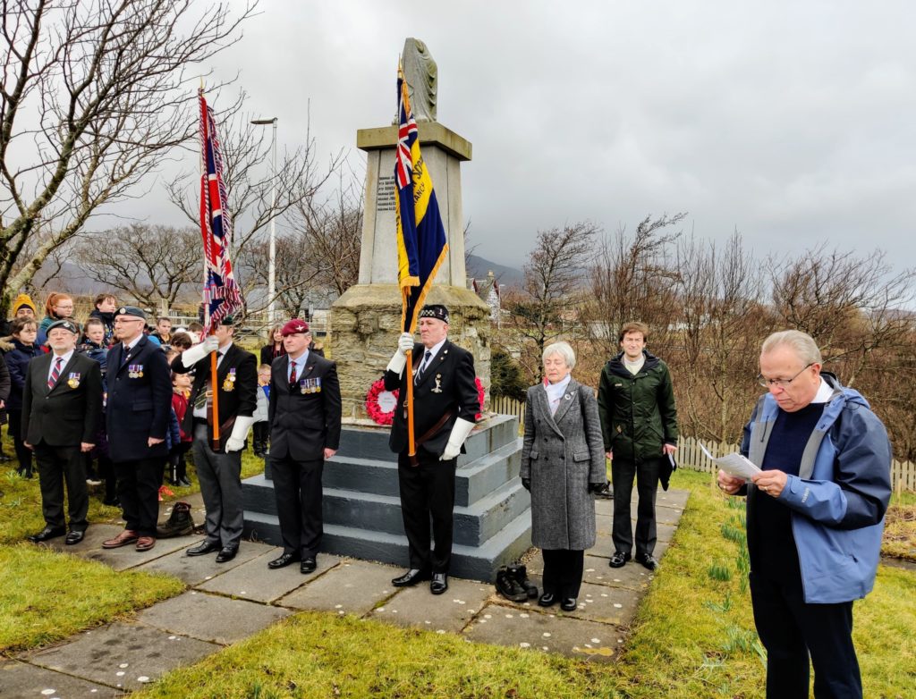 Doug Overfield, far right, cousin of Lt Paul Overfield, with his wife, other relatives and representatives of the Royal British Legion, Bun Sgoil Stafainn, and the Rev Rory MacLeod. Photograph: Staffin Community Trust. NO F10 B17 service