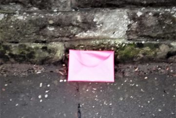 Was this pink envelope dropped, thrown away, or deliberately posed?