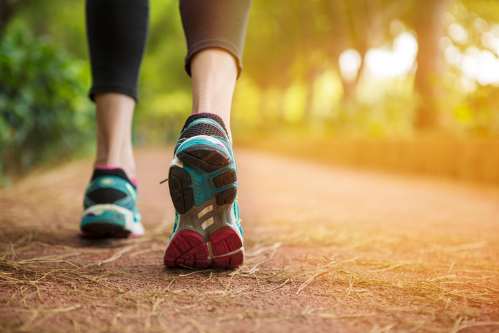 Woman running on a path close up.