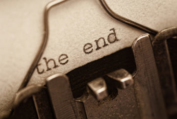 The end, words written on old vintage typewriter, sepia retro tone. the end