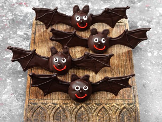 Halloween recipe, chocolate bats on a wooden board