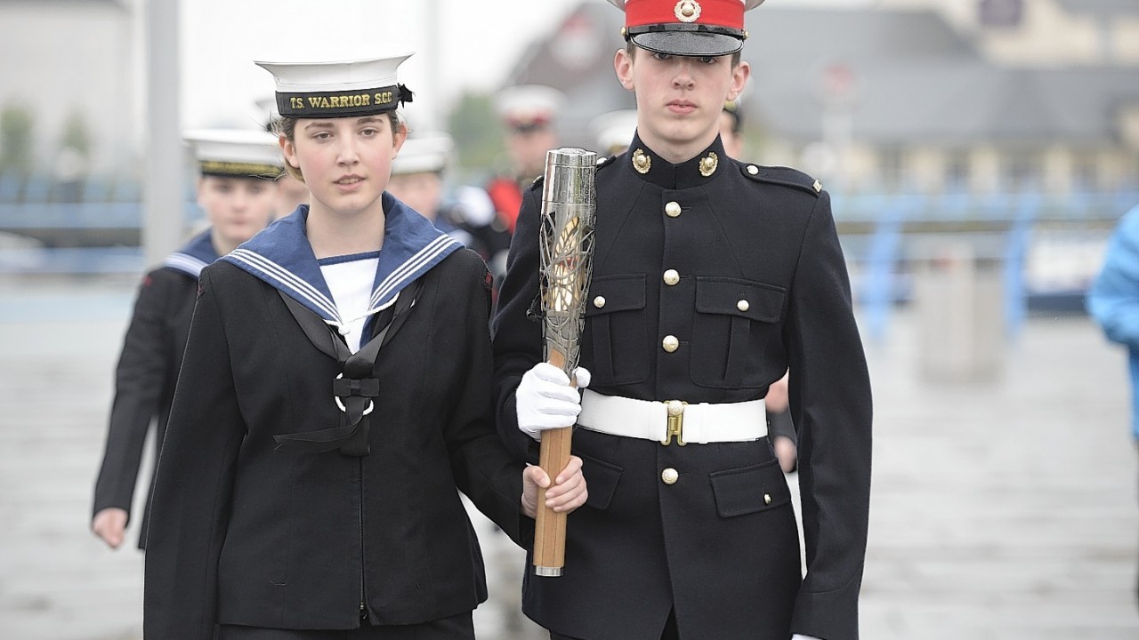 Sian and James McGilton of the TS Warrior Sea Cadets, carry the Commonwealth Games Baton in Carrickfergus