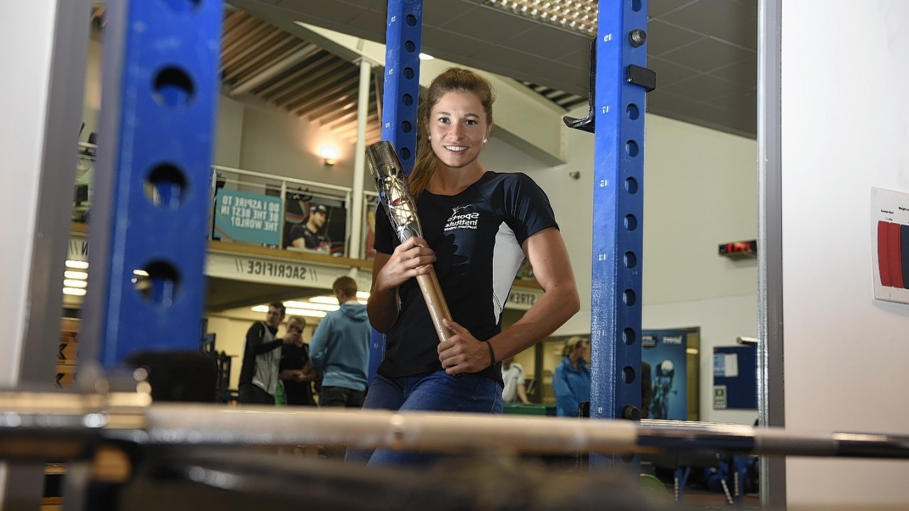 Zoe Brown, 30, representing Northern Ireland in the Pole Vault holds the Commonwealth Games Baton