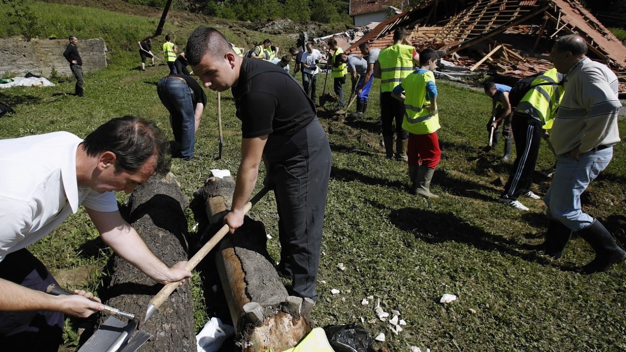 Bosnian volunteers work to save the remains of a village after a landslide near Tuzla, 140 kms north of Sarajevo