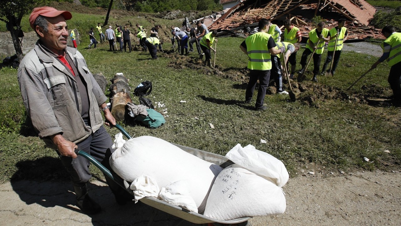 Bosnian volunteers work to save the remains of a village after a landslide near Tuzla, 140 kms north of Sarajevo