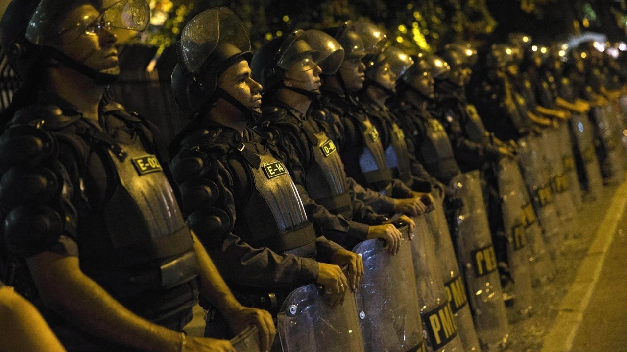 Police officers stand guard during a protest against the money spent on the World Cup preparations, in Rio de Janeiro, Brazil,