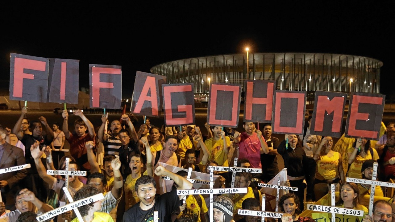 Demonstrators protest against the money spent on the World Cup in front of the National Stadium which will host the international soccer tournament's match in Brasilia, Brazil