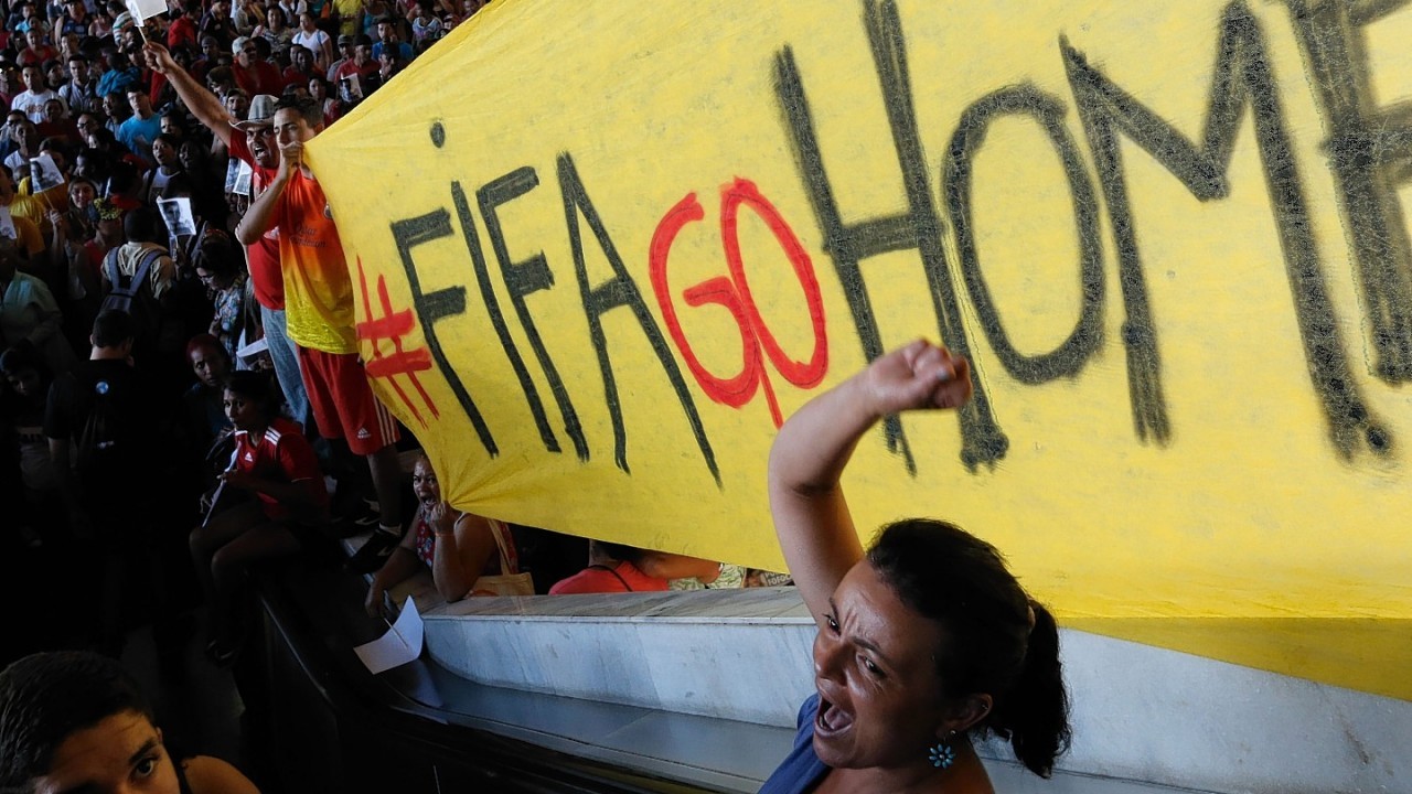 A demonstrator shout slogans against FIFA during a protest against FIFA World Cup, at a bus station in Brasilia, Brazil,