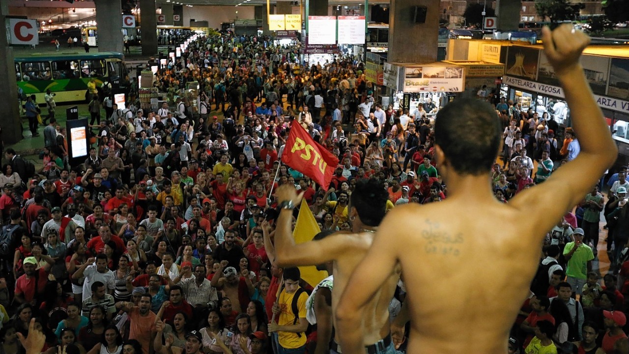 Demonstrators shout slogans against FIFA during a protest against FIFA World Cup, at the bus station in Brasilia, Brazil