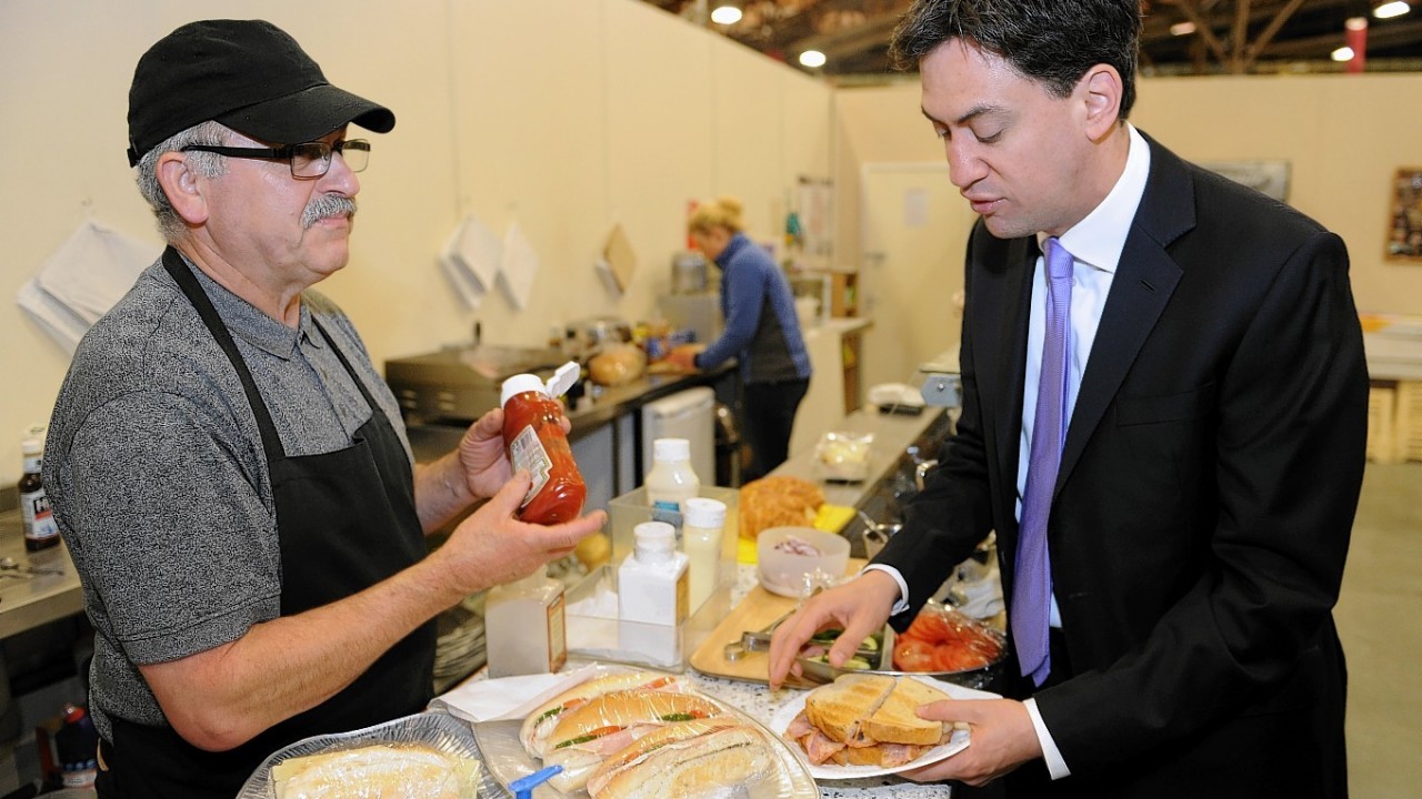 Labour leader Ed Miliband buys a bacon sandwich from cafe owner Antonios Foufas at New Covent Garden Market in London as he kicks off a day of campaigning on the eve of the local and European elections
