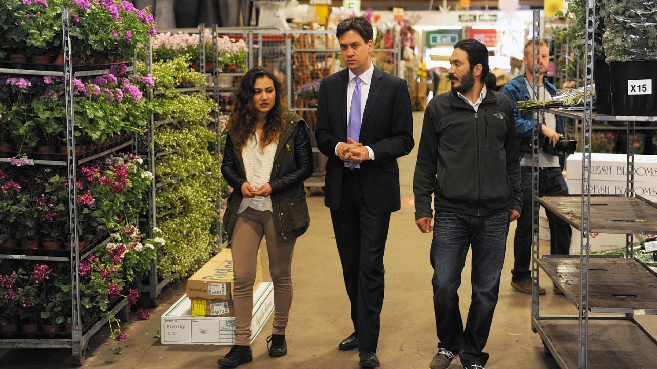 Labour leader Ed Miliband talks with a couple of traders at New Covent Garden Market in London as he kicks off a day of campaigning on the eve of the local and European elections