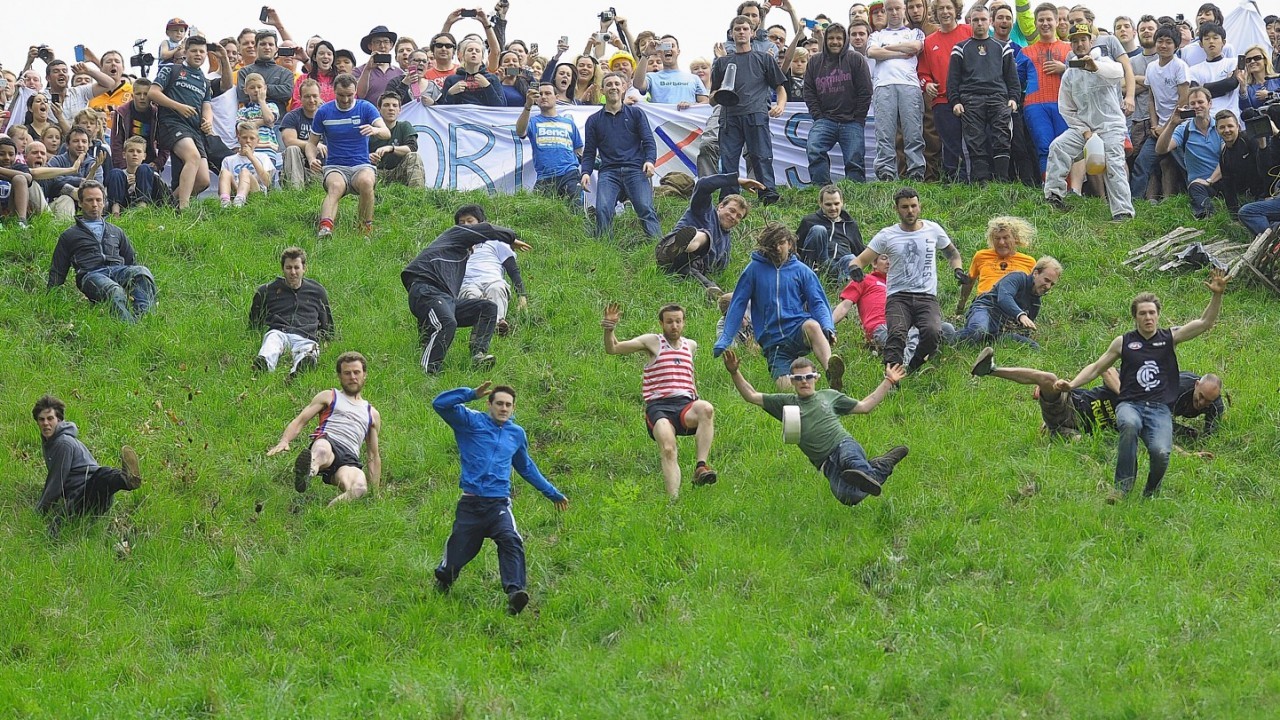 Competitors in the Cheese Rolling on Cooper's Hill race near Brockworth, Gloucestershire