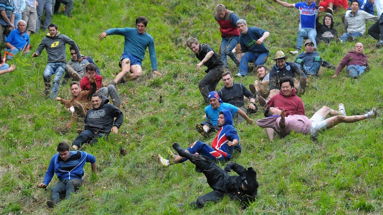 Competitors in the Cheese Rolling on Cooper's Hill race near Brockworth, Gloucestershire