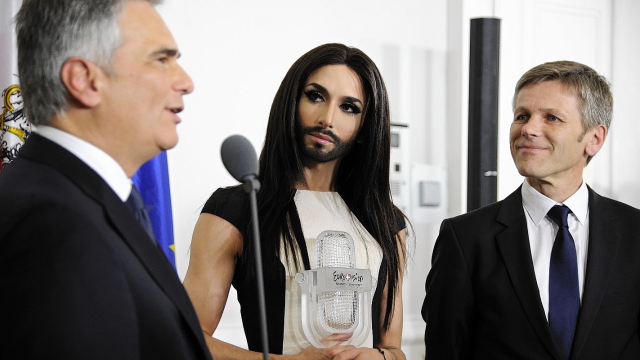 Austrian Federal Chancellor Werner Faymann, left, and Federal Minister for Arts and Culture Josef Ostermayer, right, welcome Austrian singer and Eurovision Song Contest winner Conchita Wurst at the federal chancellery in Vienna