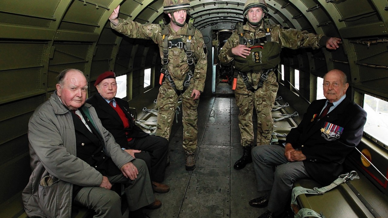 (From left) Tom Welsh, aged 88, Cecil Hughes, aged 88,  Sergeant Alan Jackson of 3 Para, Corporal Nick Quinn of 2 Para and Jeff Pattinson, aged 90 during a visit by veterans of the 9th (Eastern and Home Counties) Parachute Battalion to the Merville Barracks home of the 16 Air Assault Brigade to watch current paratroopers ground training ahead of a commemorative parachute jump in Normandy