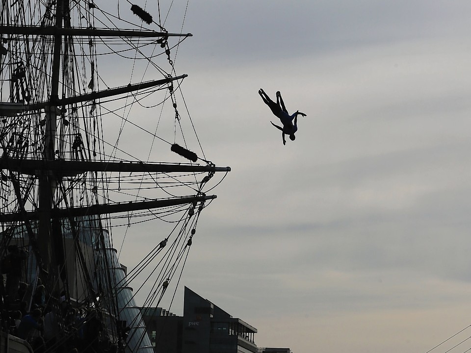 Diver Gary Hunt performs a leap from the mast of the Jeanie Johnston famine ship on the River Liffey in Dublin