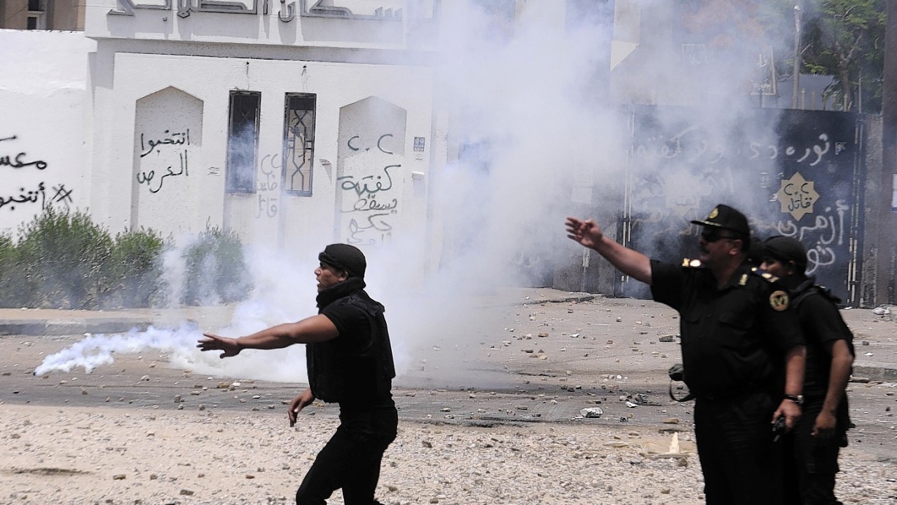 Egyptian security forces direct others during clashes with student protesters at a student housing area of Al-Azhar University in Cairo, Egypt,