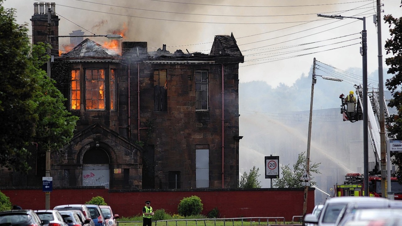 Fire fighters at the scene of a fire at a former school on Broomloan Road in Govan, Glasgow