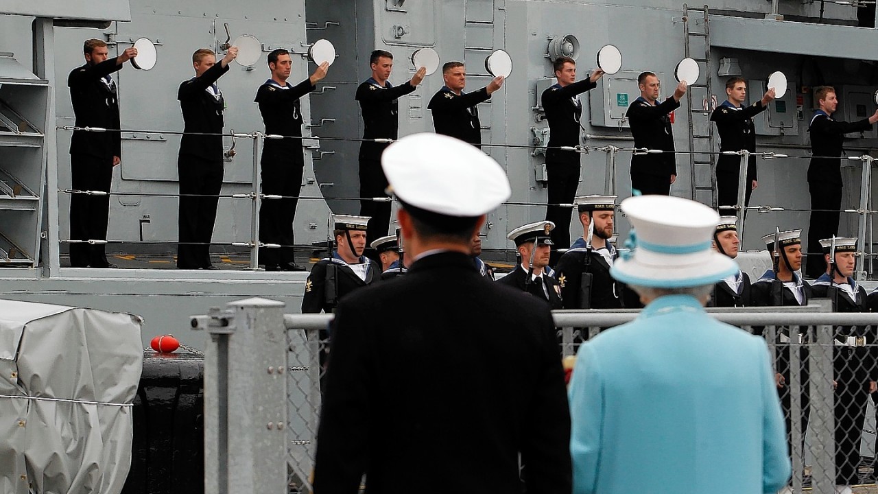 Queen Elizabeth II receives 'three cheers for Her Majesty' from the ship's company during a visit to HMS Lancaster at Portsmouth Naval Base, Hampshire