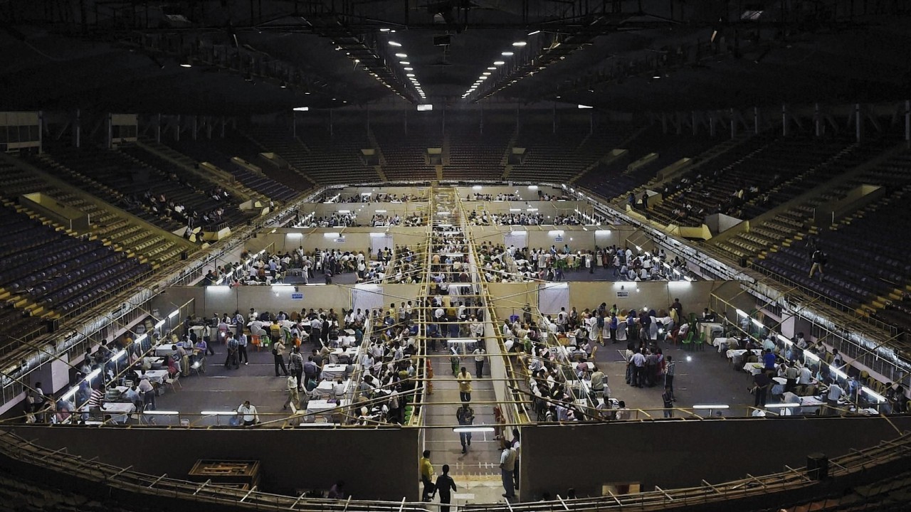 Indian election officials count votes at an indoor stadium in Kolkata, India,