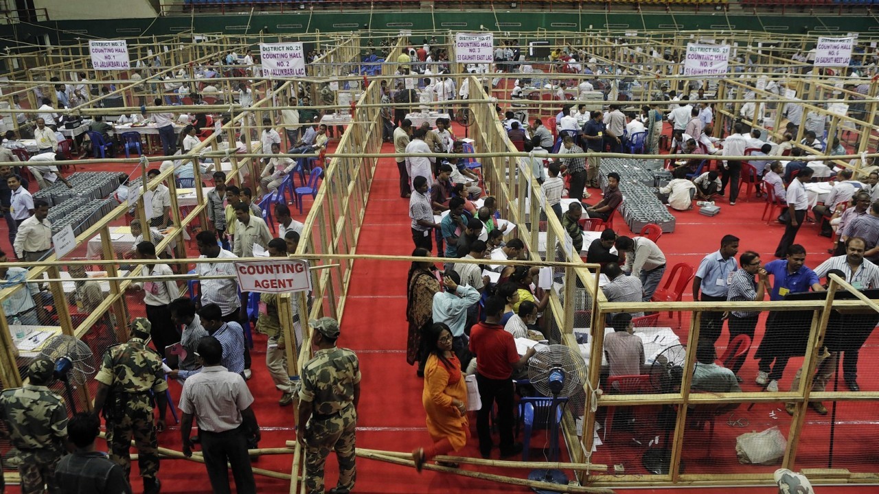Indian election officials count votes at an indoor stadium in Kolkata, India,