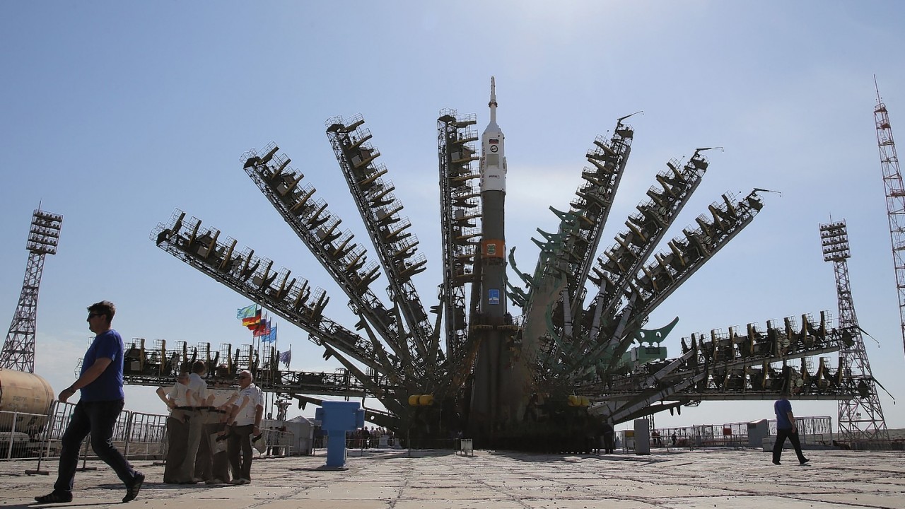 In this multiple exposure photo, service towers lift to the Russia's Soyuz-FG booster rocket with the space capsule Soyuz TMA-13M that will carry a new crew to the International Space Station (ISS), at the launch pad at the Russian leased Baikonur Cosmodrome, Kazakhstan