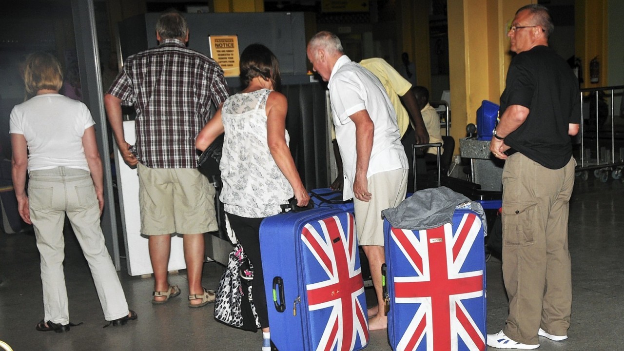 British tourists queue to prepare to leave the international airport in Mombasa, Kenya