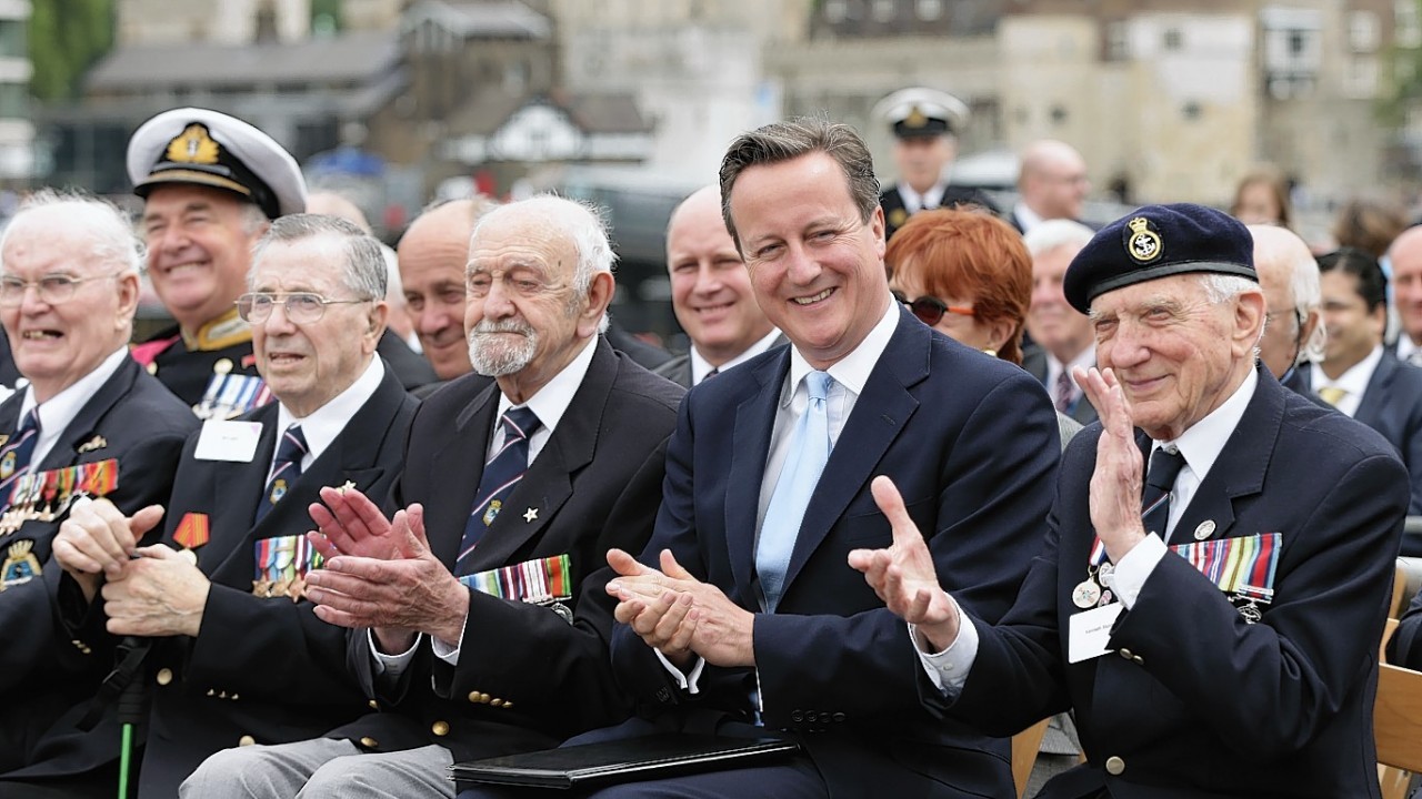 Prime Minister David Cameron with D-Day Veterans on board the Second World War warship HMS Belfast in London, during a ceremony to mark the 70th anniversary of the historic Normandy Landings