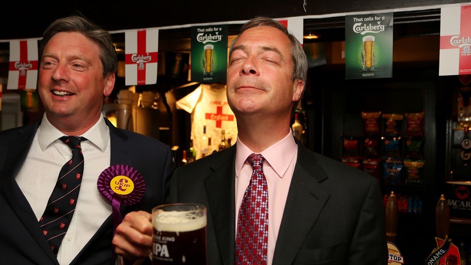 Ukip leader Nigel Farage, right, takes a moment to enjoy his party's success in the local elections