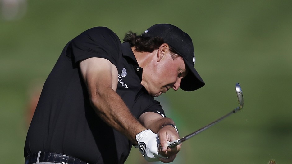 Phil Mickelson, who has been playing in the Memorial golf tournament in Dublin, Ohio, said he is cooperating with an insider trading probe (AP)