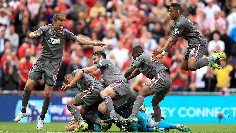 Rotherham goalkeeper Adam Collin is mobbed by his teammates after penalty shoot-out win.