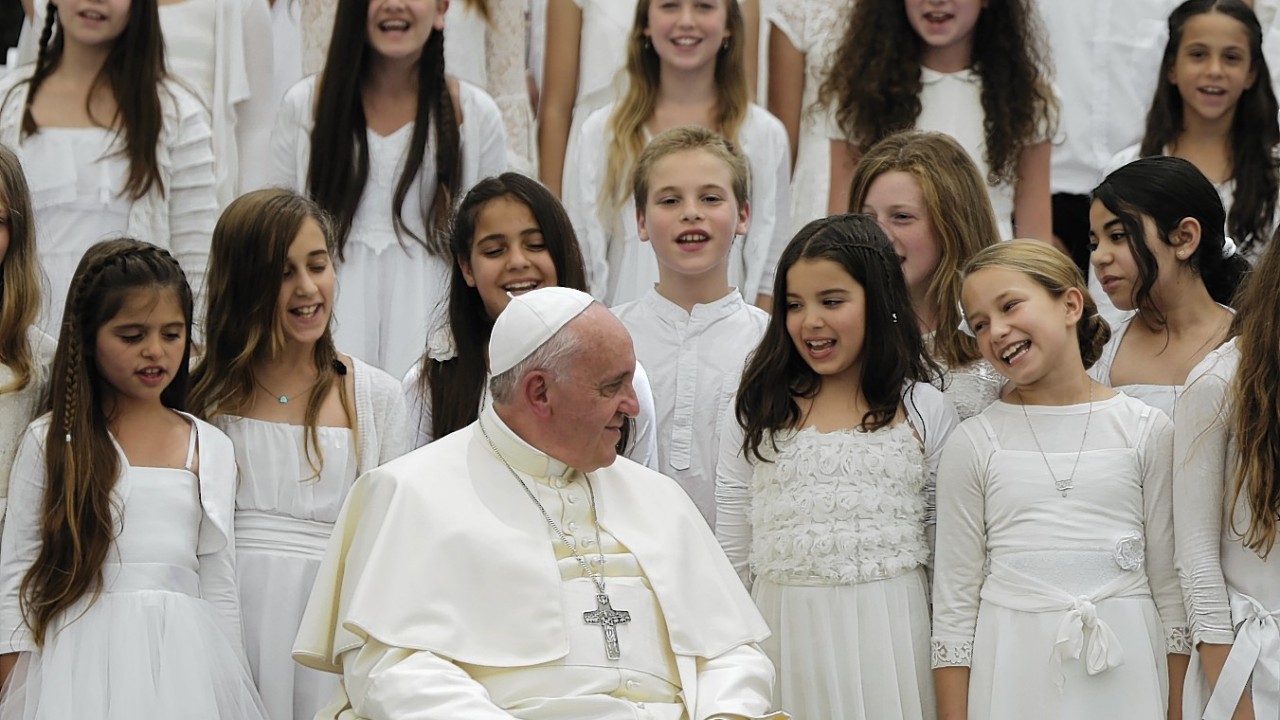 Pope Francis listens to a choir during a reception with Israeli President Shimon Peres in Jerusalem