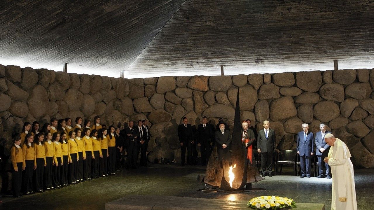 : Pope Francis lays a wreath as Israel's President Shimon Peres and Israeli Prime Minister Benjamin Netanyahu stand at the Hall of Remembrance at the Yad Vashem Holocaust memorial in Jerusalem