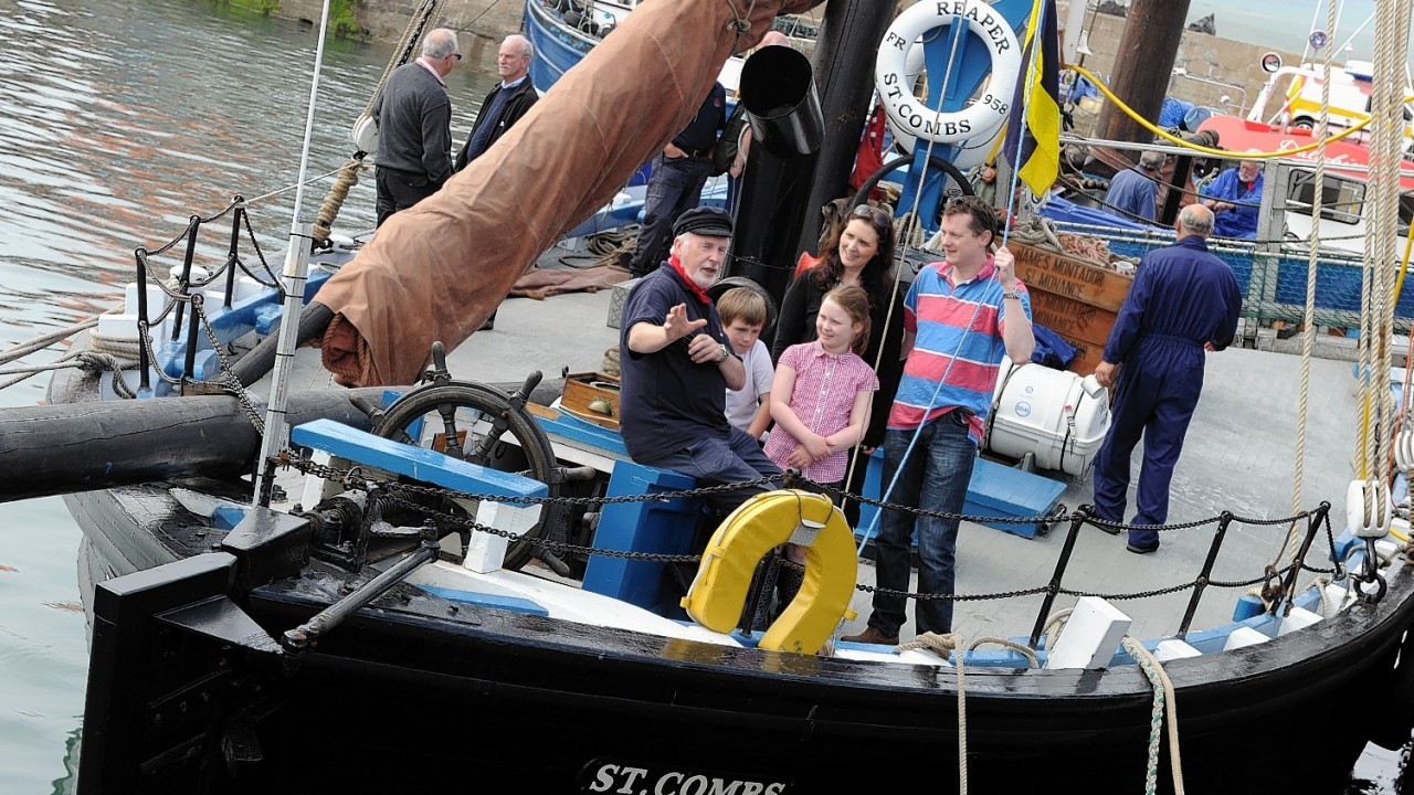 Crew member Will Taylor talks to the Macaulay family dad Graham, mum Lisa and children Blair and Rosa on board the Reaper.